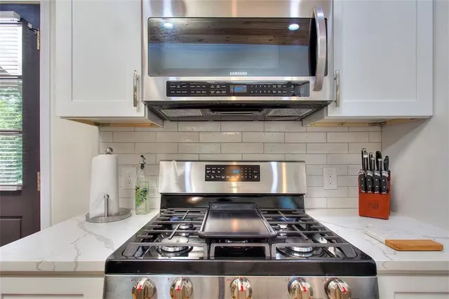 a kitchen with a stove and a microwave