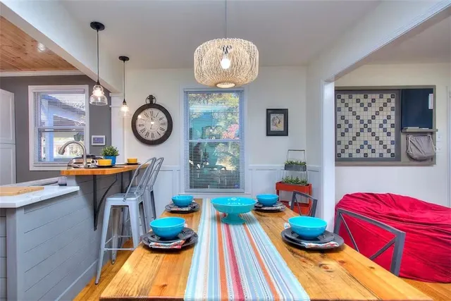 a living room with lots of furniture and paintings on the wall