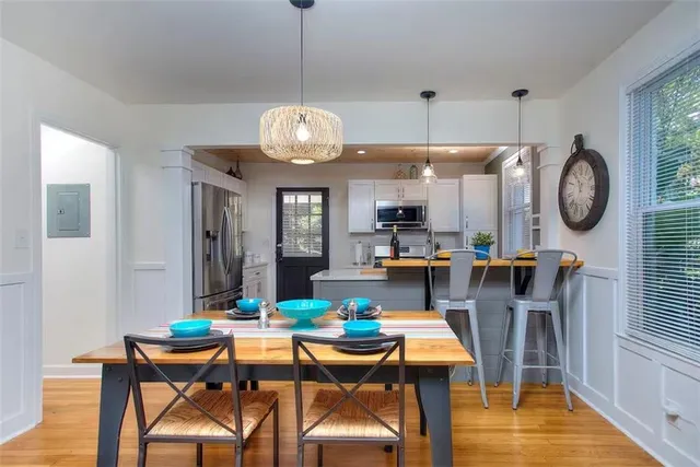 a view of a dining room and hall with furniture