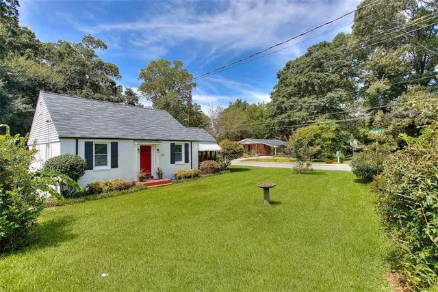 a front view of a house with a garden