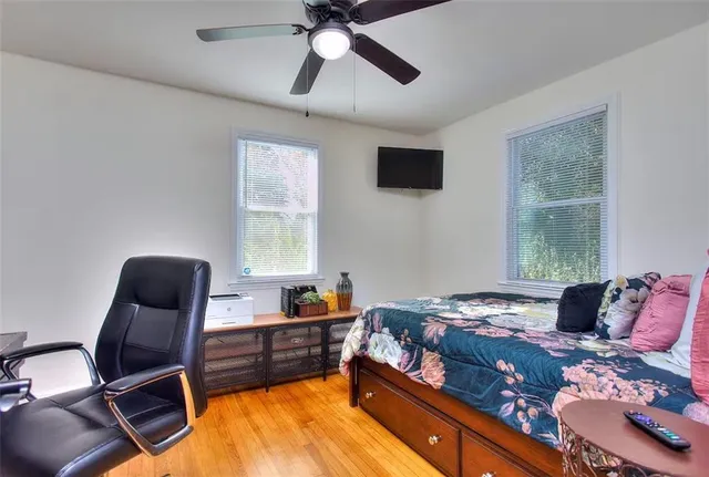 a bedroom with a bed and wooden floor