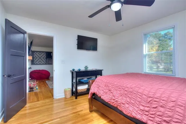 a bedroom with a large bed and a chandelier