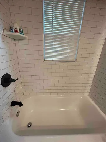 a view of a bench in the patio next to a yard