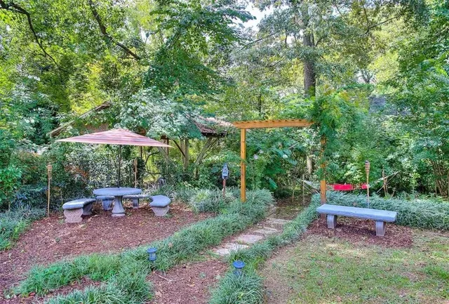 a view of a table and chairs under an umbrella