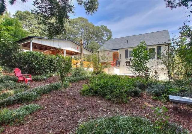 a view of a garden with an outdoor seating