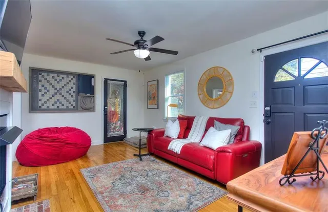 a living room with furniture and a mirror