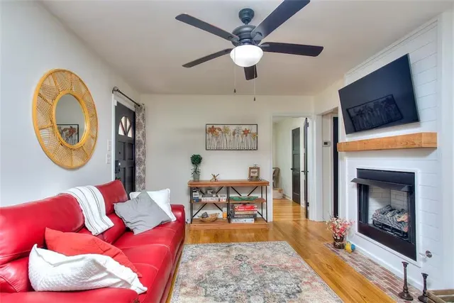 a living room with fireplace furniture and a flat screen tv