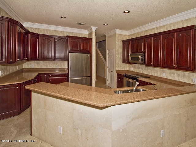 12930 Biggin Church Road South Jacksonville, FL 32224 - Photo 11 of 25 a kitchen with stainless steel appliances granite countertop a sink refrigerator and cabinets