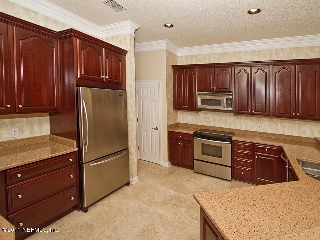 12930 Biggin Church Road South Jacksonville, FL 32224 - Photo 12 of 25 a kitchen with stainless steel appliances granite countertop a refrigerator stove and sink