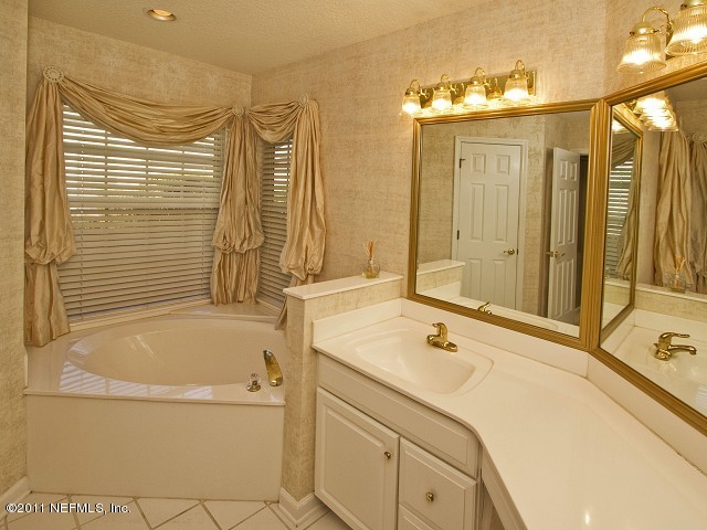 12930 Biggin Church Road South Jacksonville, FL 32224 - Photo 18 of 25 a bathroom with a tub sink and mirror