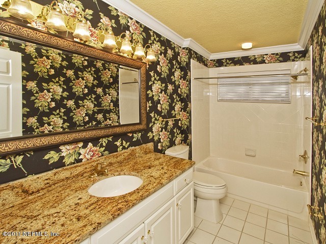 12930 Biggin Church Road South Jacksonville, FL 32224 - Photo 7 of 25 a bathroom with a granite countertop sink a toilet and shower