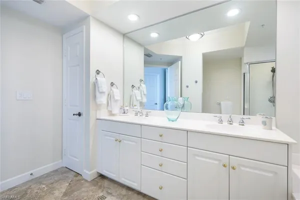a bathroom with a double vanity sink and mirror