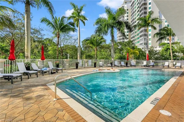 a view of swimming pool with sitting area and slide