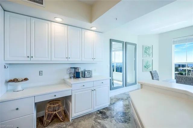 a room with a white cabinets and sink