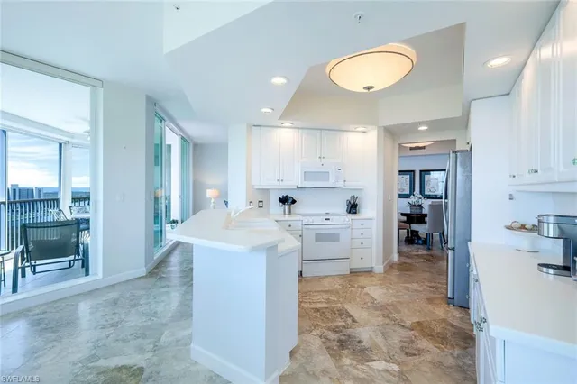 a large kitchen with kitchen island a sink stainless steel appliances and cabinets