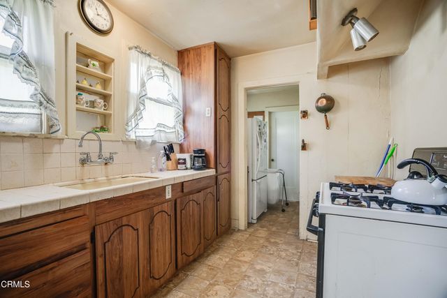 a spacious bathroom with a granite countertop sink and a mirror
