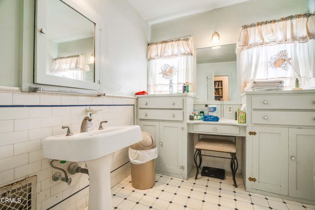 a bathroom with a sink toilet a mirror and tub