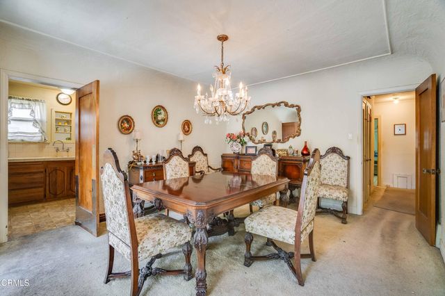 a view of a dining room with furniture and chandelier
