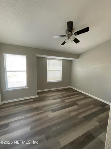 a view of empty room with ceiling fan