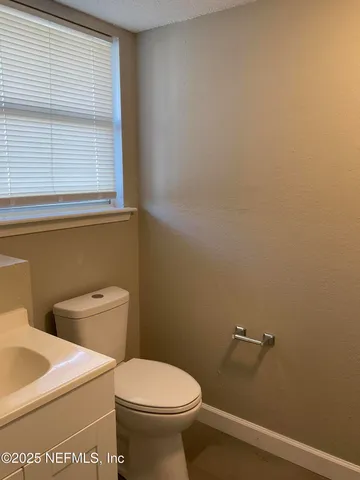 a white toilet sitting next to a window