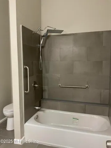 a bathroom with a shower and a toilet