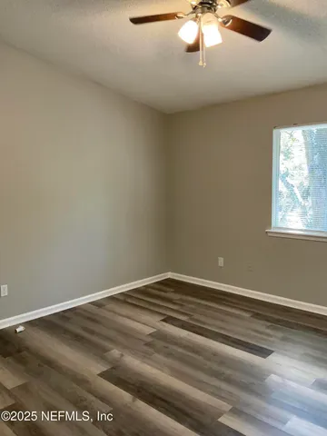 a view of room with window and ceiling fan