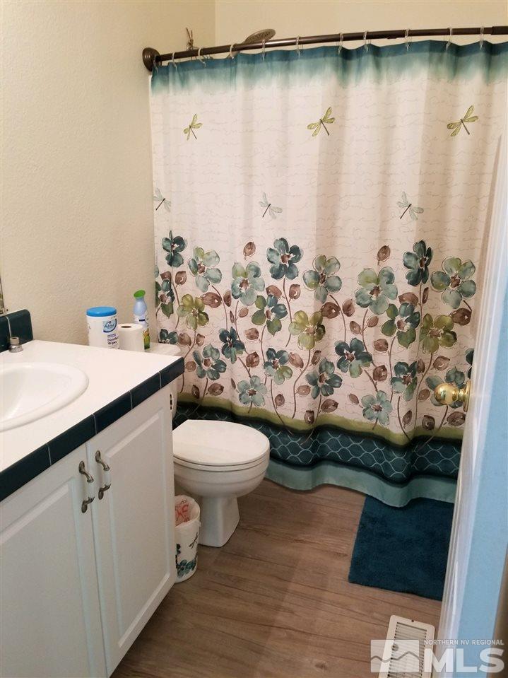 240 Magnolia Way Reno, NV 89506 - Photo 6 of 9 a bathroom with a sink toilet and shower