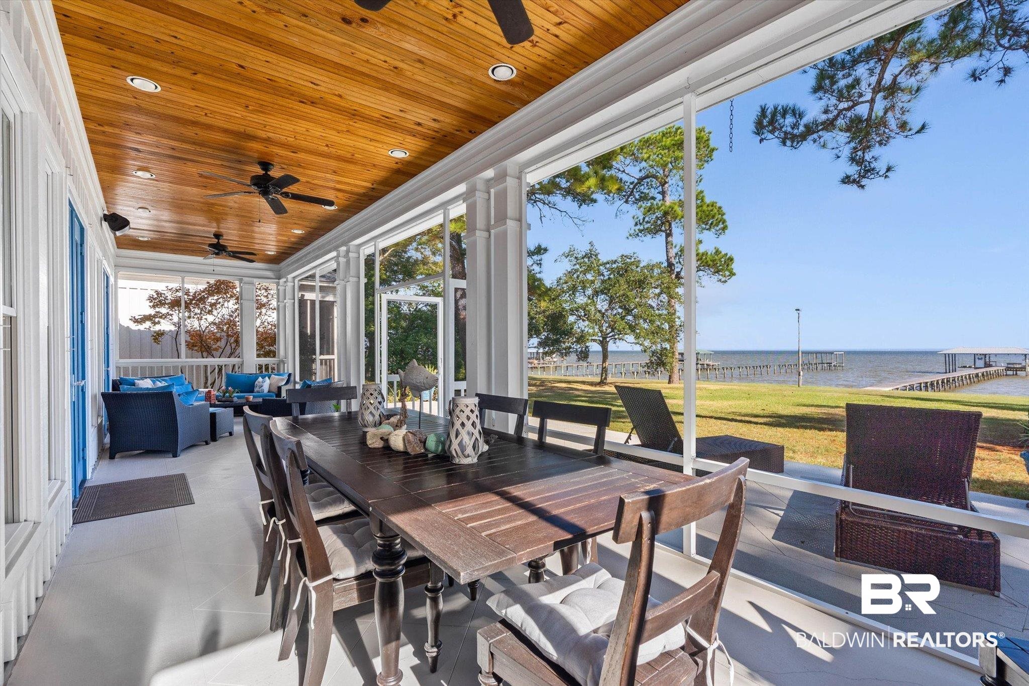 7015 Bay Road Mobile, AL 36605 - Photo 31 of 53 screened in porch / outdoor living space, a water view, ceiling fan, and outdoor dining space