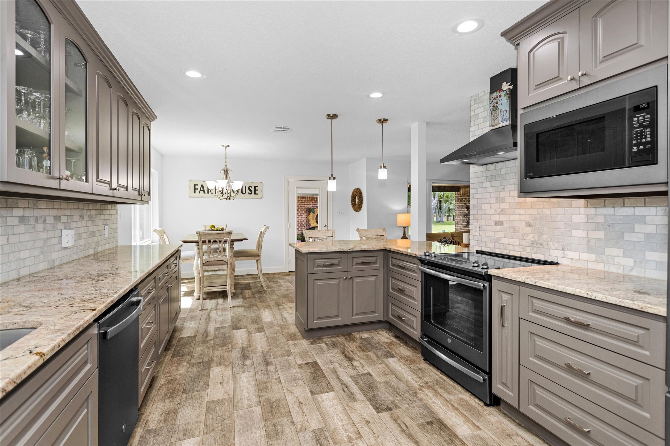 4402 Spears Road Manvel, TX 77578 - Photo 19 of 38 a kitchen with stainless steel appliances granite countertop a stove a sink and a microwave