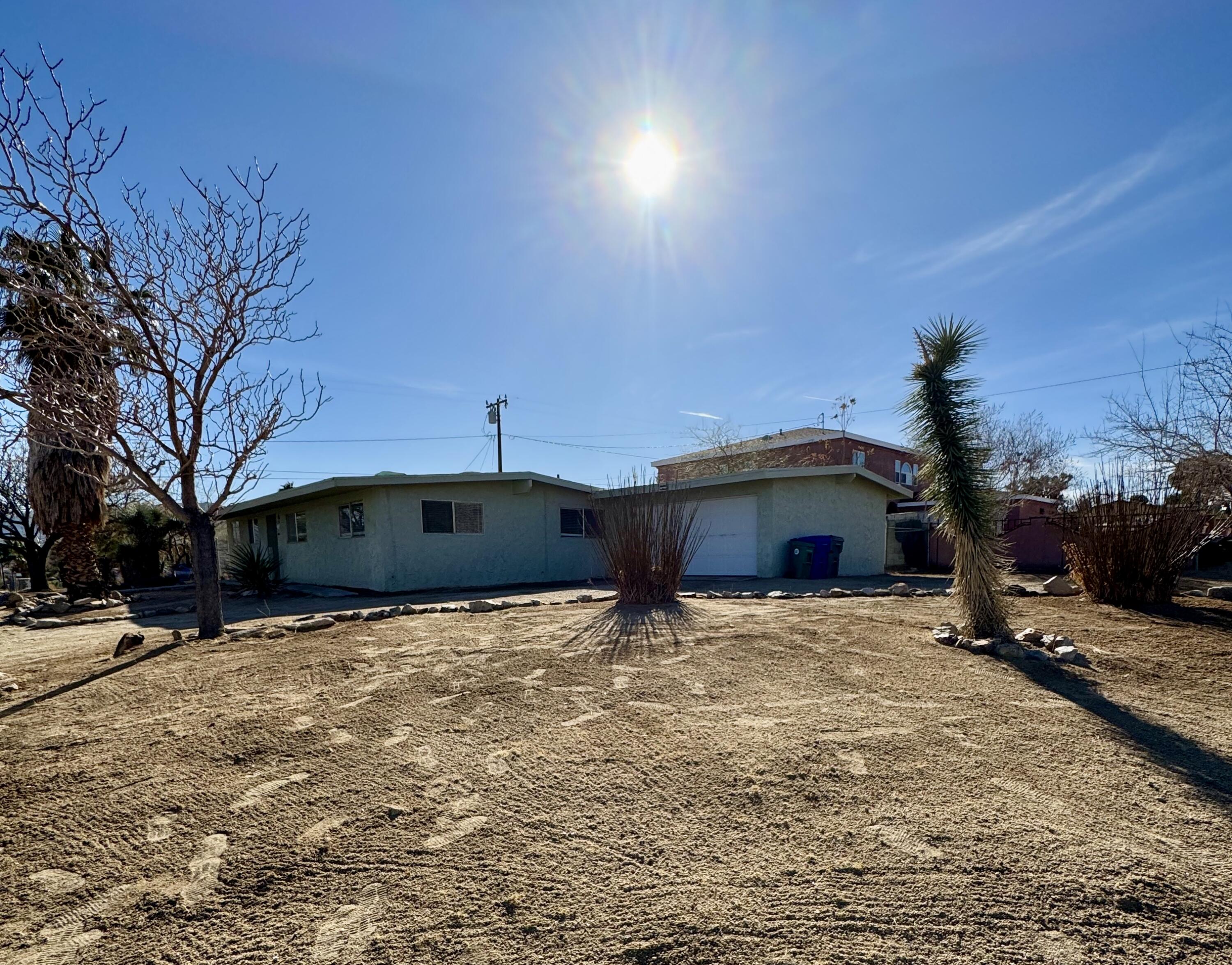 5958 El Reposo Street Joshua Tree, CA 92252 - Photo 11 of 30 a front view of a house with a yard