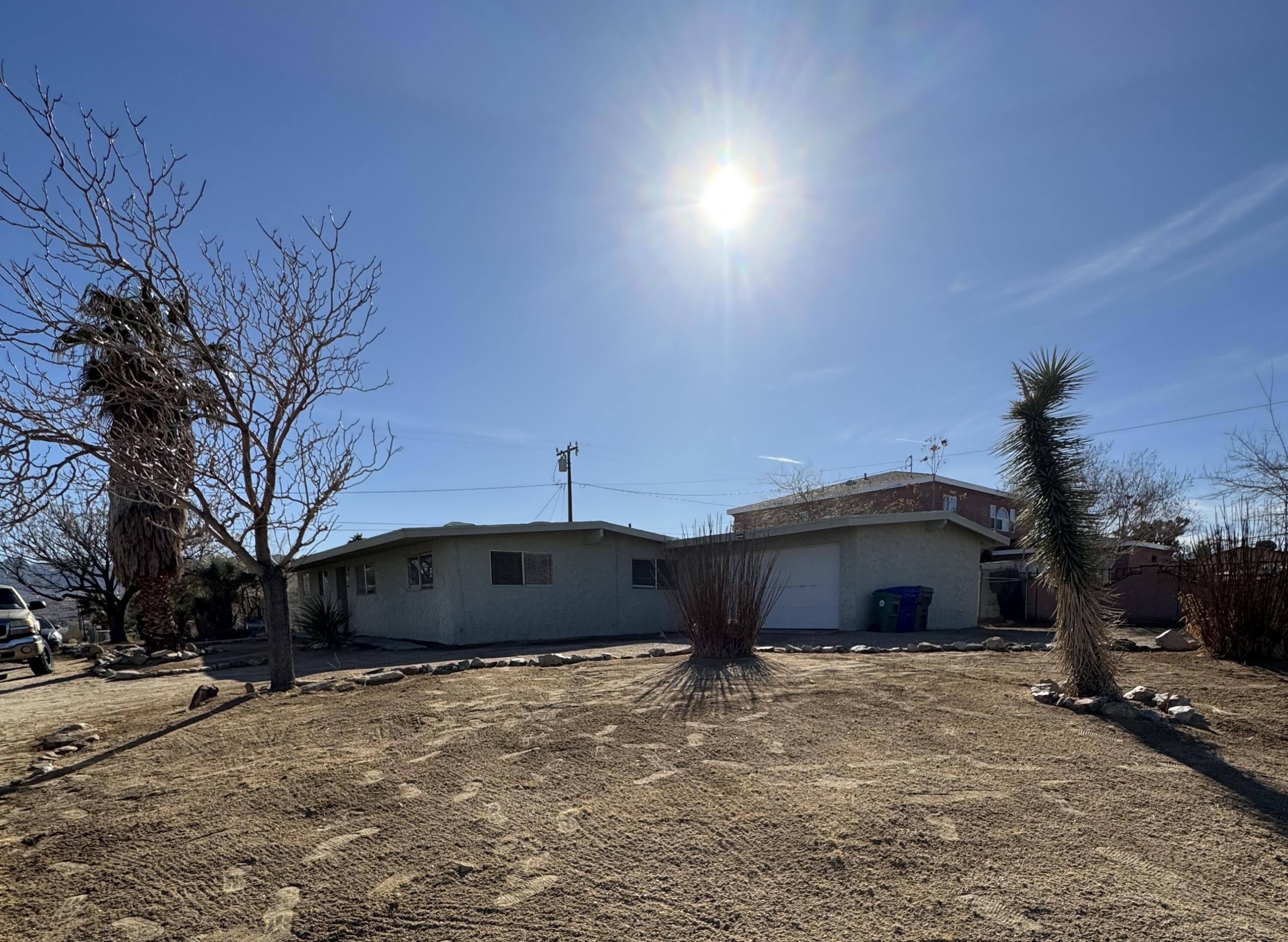 5958 El Reposo Street Joshua Tree, CA 92252 - Photo 12 of 30 a front view of a house with a yard and parking space