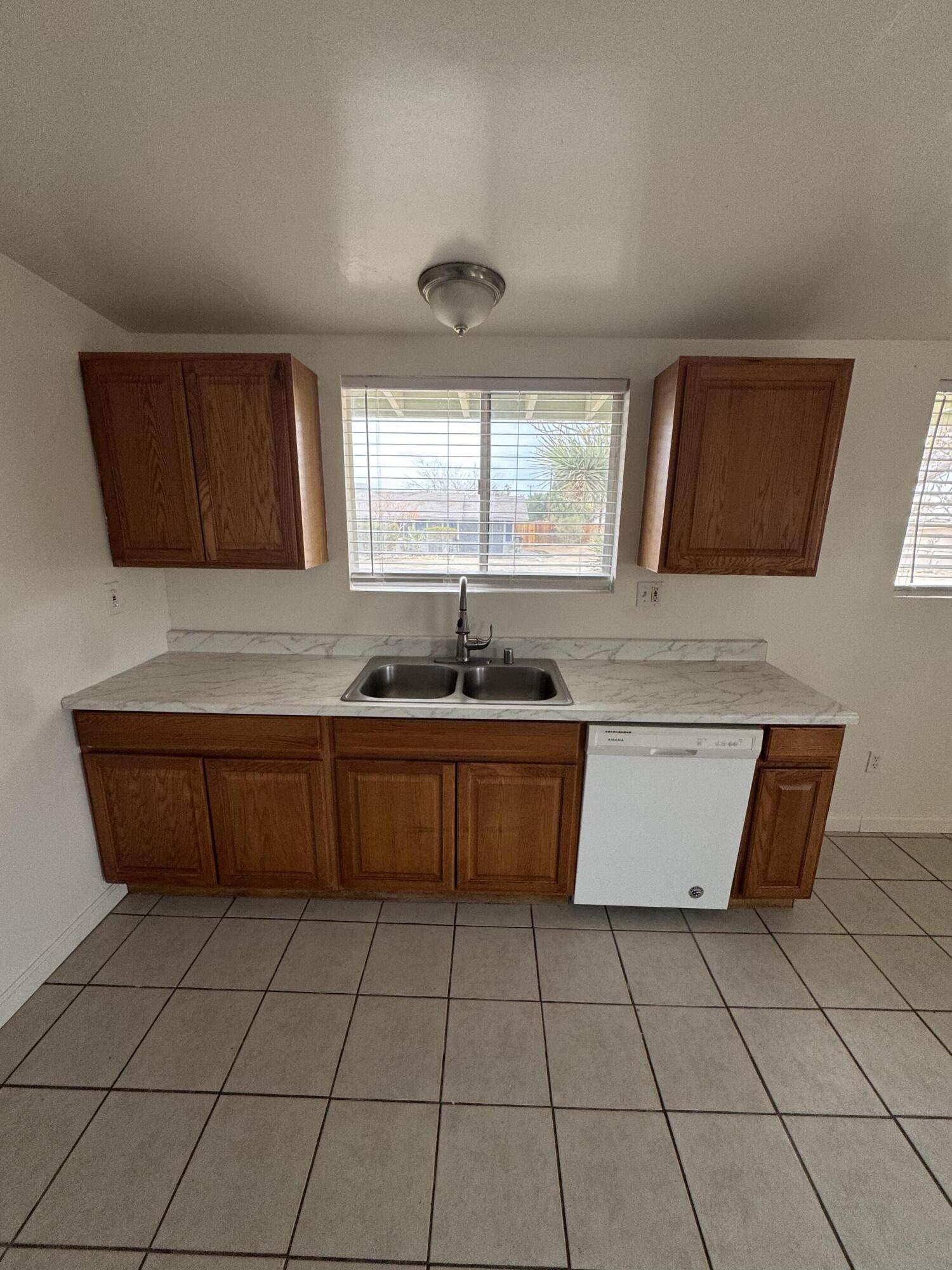 5958 El Reposo Street Joshua Tree, CA 92252 - Photo 17 of 30 a kitchen with stainless steel appliances a sink a counter top space cabinets and a window