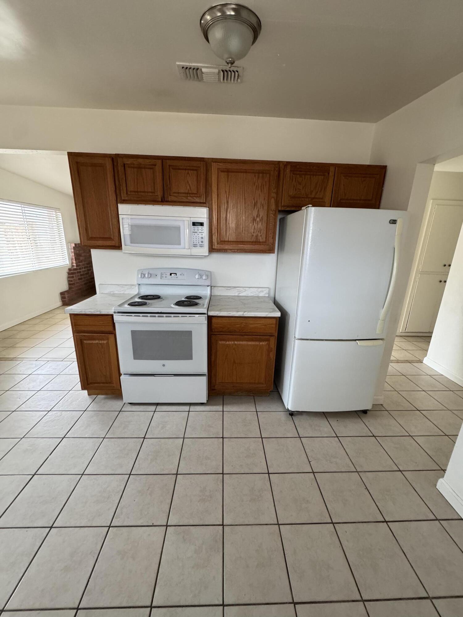 5958 El Reposo Street Joshua Tree, CA 92252 - Photo 18 of 30 a kitchen with a stove top oven and cabinets
