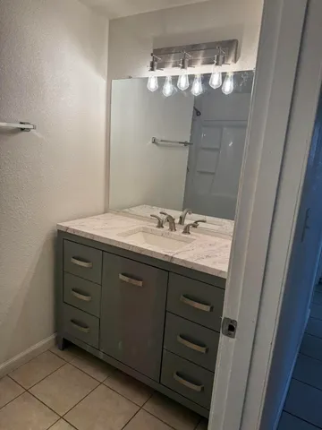 a bathroom with a sink vanity and a mirror