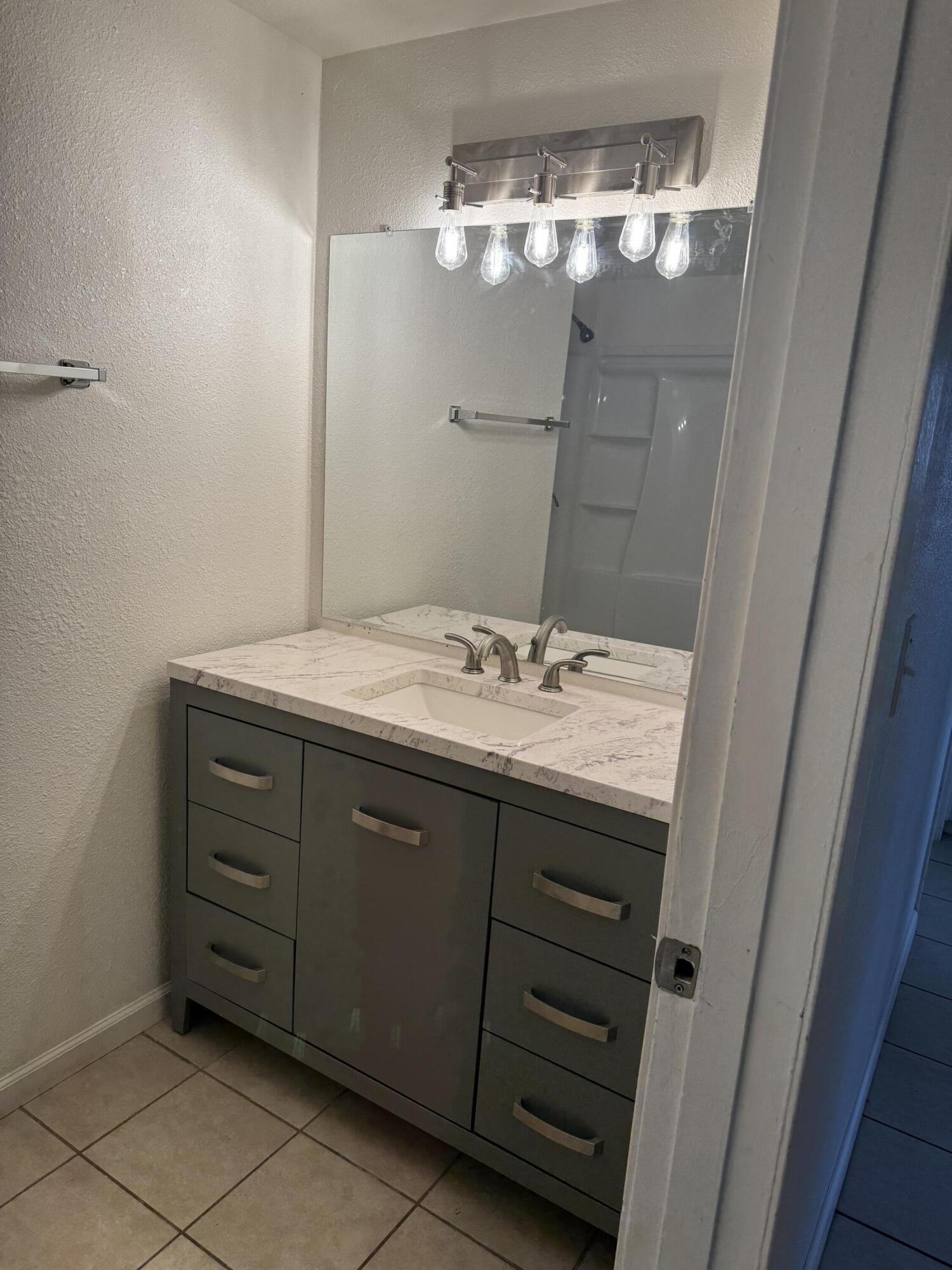 5958 El Reposo Street Joshua Tree, CA 92252 - Photo 20 of 30 a bathroom with a sink vanity and a mirror