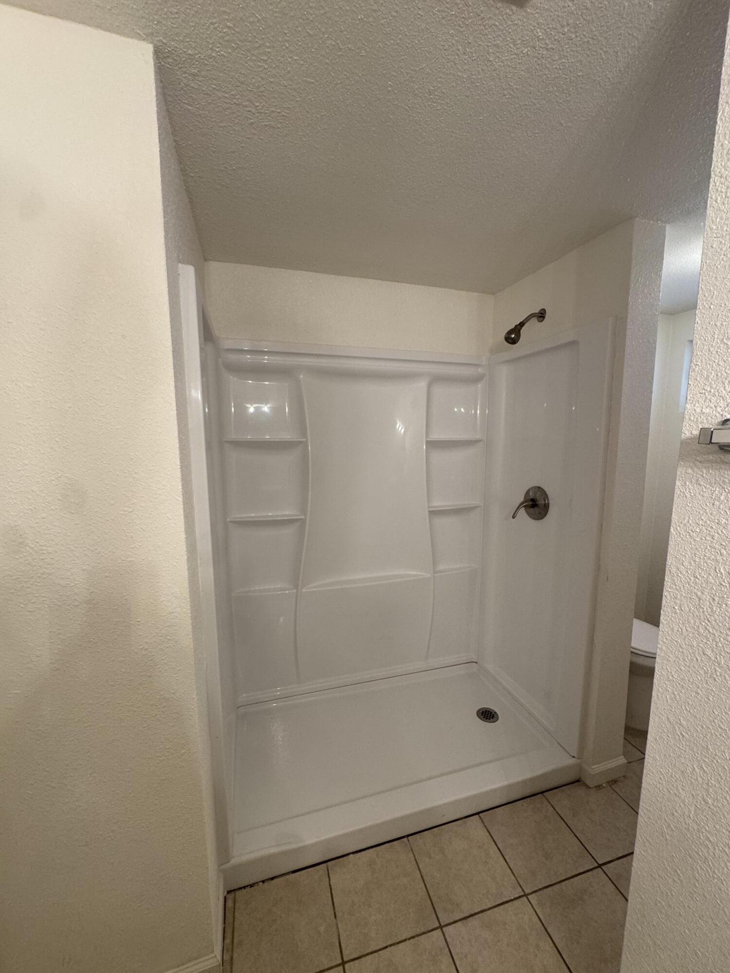 5958 El Reposo Street Joshua Tree, CA 92252 - Photo 23 of 30 a bathroom with a glass shower door