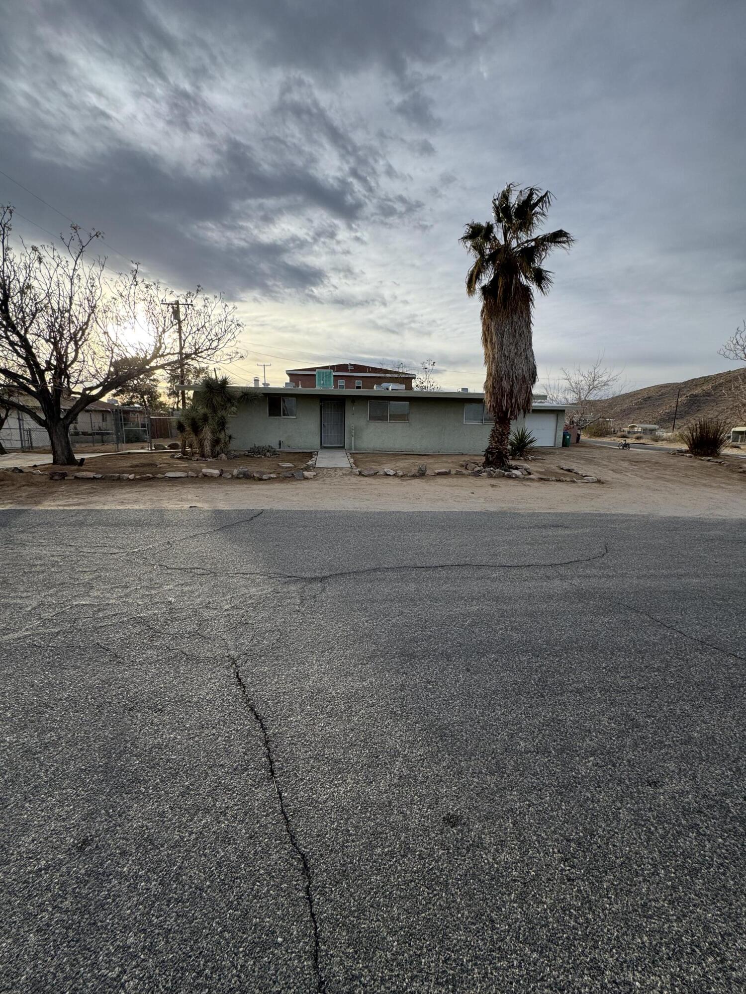 5958 El Reposo Street Joshua Tree, CA 92252 - Photo 30 of 30 a front view of a house with a yard