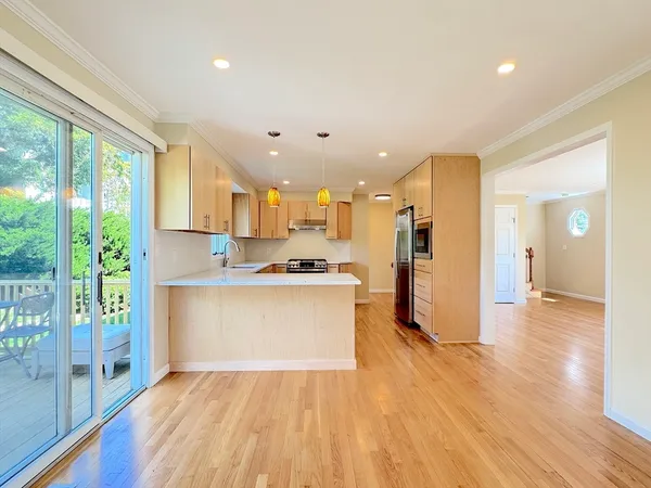 a view of large kitchen with stainless steel appliances cabinets