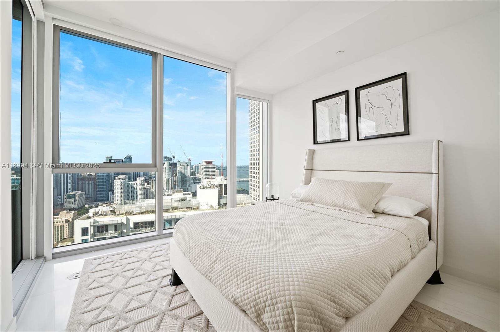 300 Biscayne Blvd Way, Unit 4909W Miami, FL 33131 - Photo 19 of 47 a bedroom with a large bed and a large window