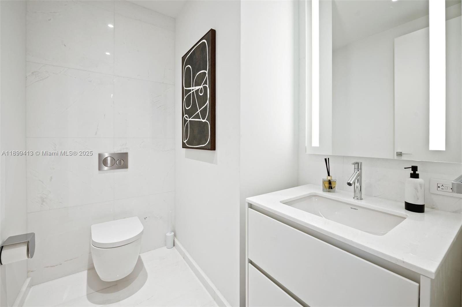 300 Biscayne Blvd Way, Unit 4909W Miami, FL 33131 - Photo 21 of 47 a bathroom with a toilet sink and mirror