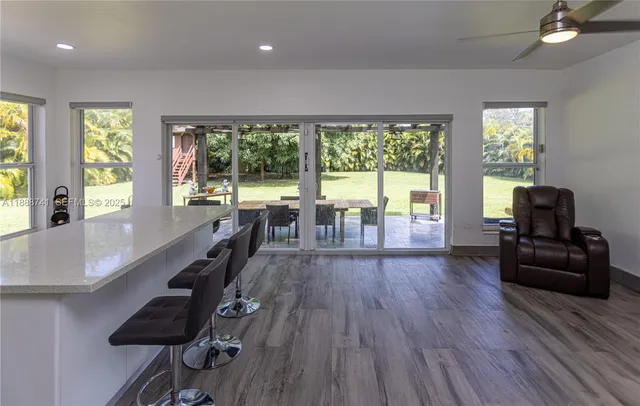 a dining room with furniture and a kitchen view