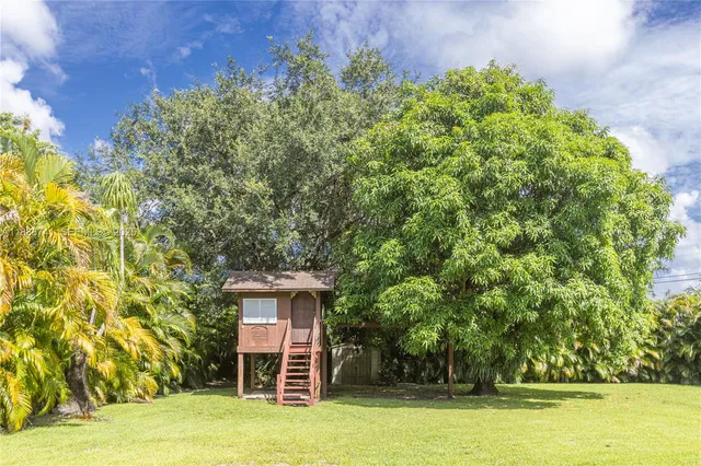 a spacious bedroom with a bed and a large window with the outer view