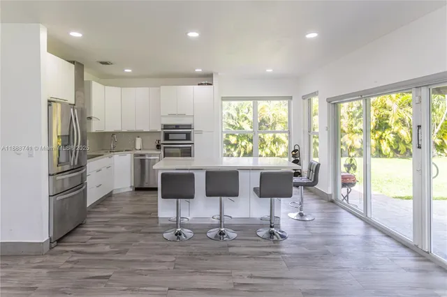 a large kitchen with a large counter top appliances and cabinets