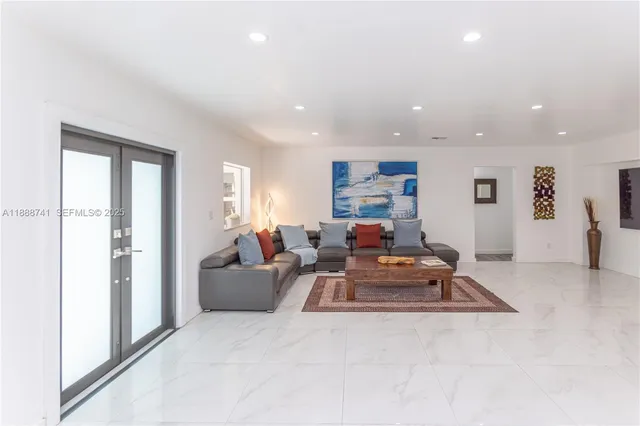 a bedroom with a bed and painting on the wall