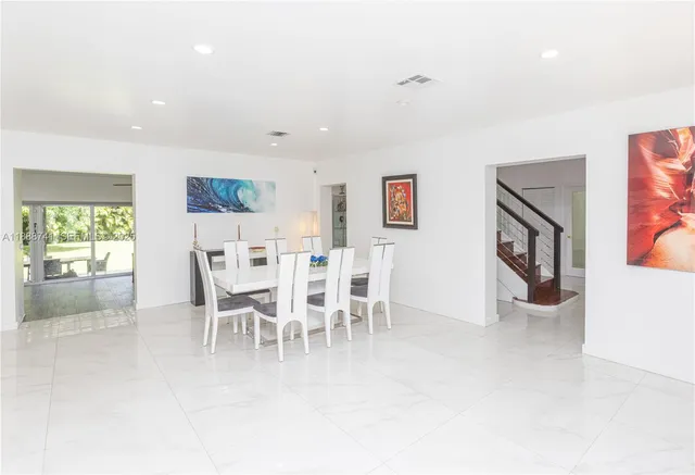 a view of a room with wooden floor and a window