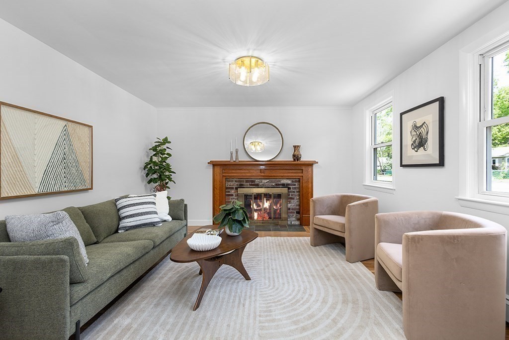 117 Oak Ridge Drive Ayer, MA 01432 - Photo 5 of 26 a living room with furniture a chandelier and a fireplace