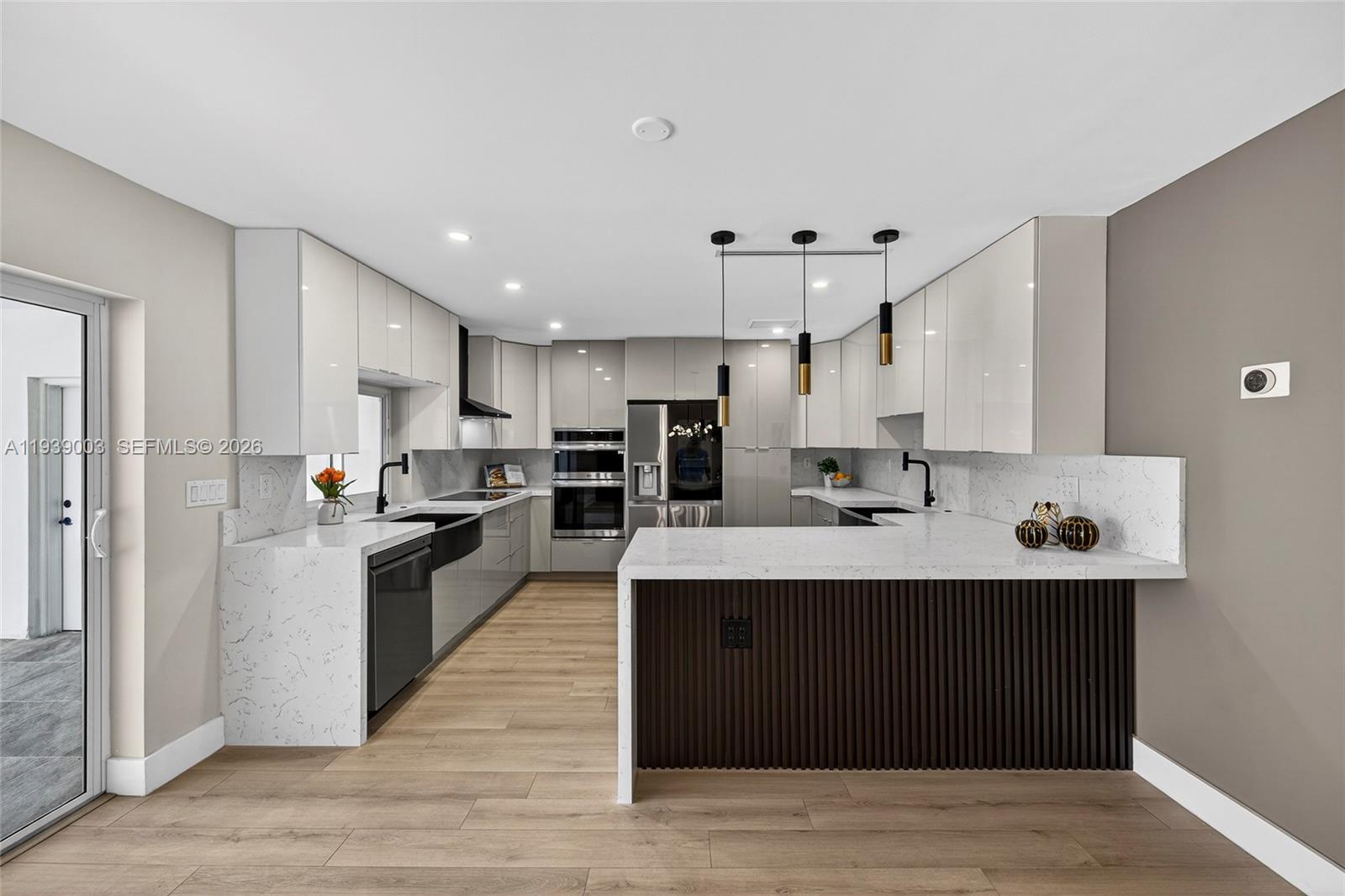 4712 Cleveland Street Hollywood, FL 33021 - Photo 15 of 49 a large kitchen with stainless steel appliances a sink dishwasher stove and refrigerator