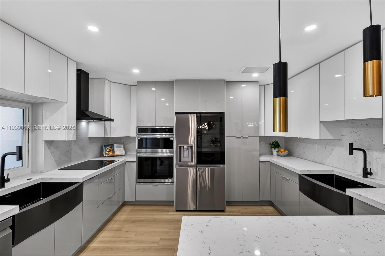 4712 Cleveland Street Hollywood, FL 33021 - Photo 16 of 49 a kitchen with stainless steel appliances granite countertop a sink a stove and a refrigerator