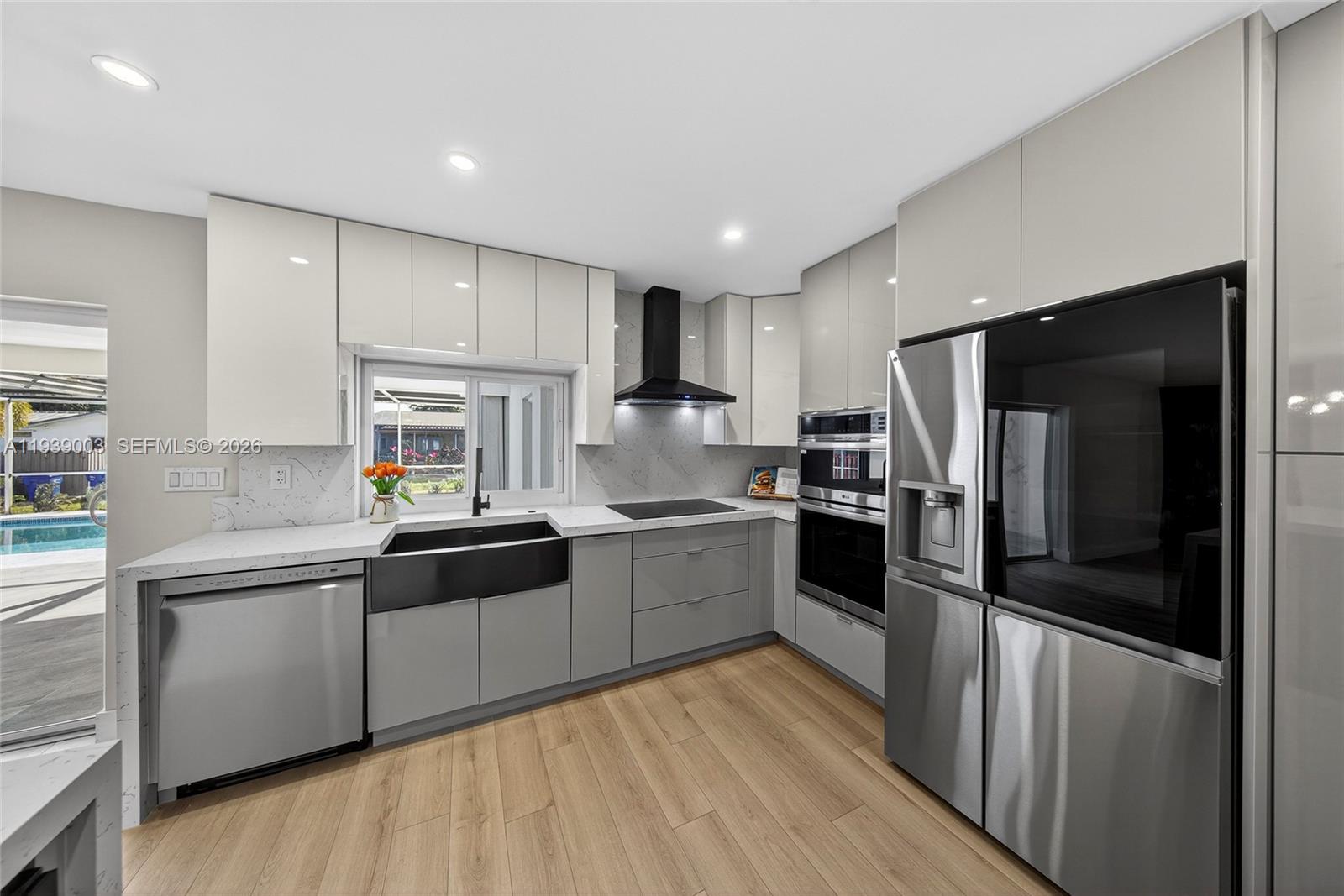 4712 Cleveland Street Hollywood, FL 33021 - Photo 18 of 49 a large kitchen with a large counter top appliances and cabinets