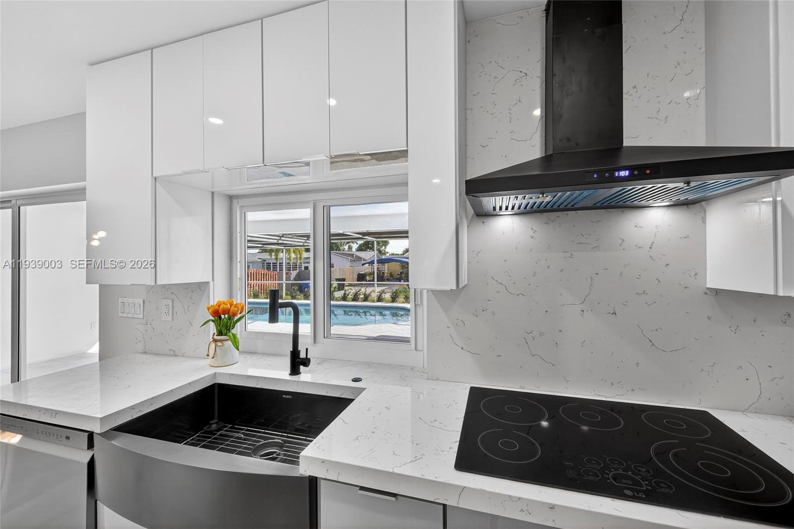 4712 Cleveland Street Hollywood, FL 33021 - Photo 19 of 49 a kitchen with a sink and a stove top oven
